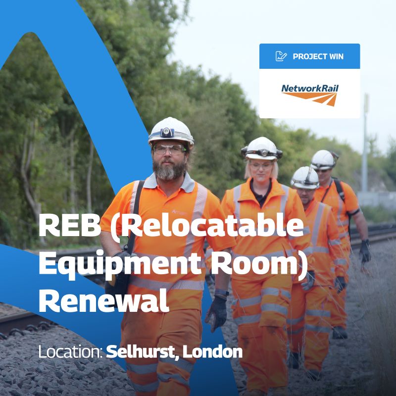 A promotional graphic announcing a project win for REB (Relocatable Equipment Room) Renewal at Selhurst, London. The image features a group of workers in high-visibility orange safety gear and helmets walking along a railway track. The text “REB (Relocatable Equipment Room) Renewal” is prominently displayed in bold white letters, with “Location: Selhurst, London” noted below. In the top right corner, a blue label reads “PROJECT WIN” next to the Network Rail logo. The background includes a blue design element on the left side.