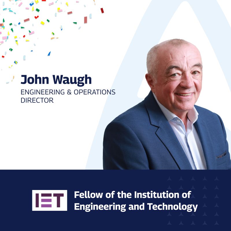 A celebratory graphic featuring John Waugh, the Engineering & Operations Director, who has been recognized as a Fellow of the Institution of Engineering and Technology (IET). The image includes a professional portrait of John on the right, with colorful confetti in the top left corner. His name and title are displayed on the left in bold text, and the IET logo with the recognition “Fellow of the Institution of Engineering and Technology” is prominently shown at the bottom on a dark blue background.