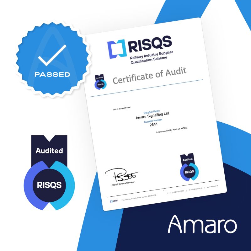 A graphic featuring a ‘Certificate of Audit’ from RISQS (Railway Industry Supplier Qualification Scheme) awarded to Amaro Signalling Ltd. The certificate has a blue and white design with the RISQS logo at the top. A blue badge with a checkmark reading ‘PASSED’ and another badge stating ‘Audited’ are prominently displayed. The Amaro company logo is also visible at the bottom.