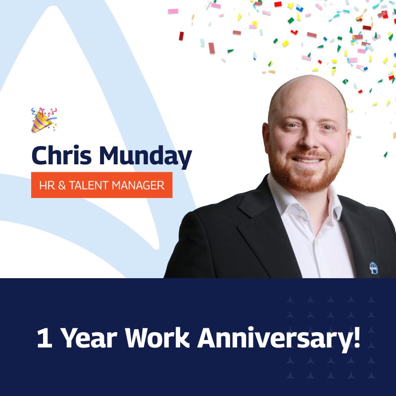 A celebratory graphic marking the 1 Year Work Anniversary of Chris Munday, the HR & Talent Manager at Amaro. Chris, a bald man with a beard, is smiling and dressed in a suit. The graphic features a festive background with multicolored confetti and a large celebratory text that reads ‘1 Year Work Anniversary!’ The background is creatively divided with a white triangular design and a dark blue section at the bottom filled with small white stars.