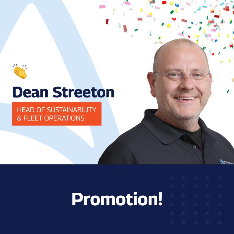 A celebratory graphic announcing the promotion of Dean Streeton to Head of Sustainability & Fleet Operations at Amaro. Dean, a smiling man with glasses and a short beard, wears a black polo shirt with the Amaro logo. The background features colorful confetti and design elements, including a waving hand emoji. The text ‘Promotion!’ is displayed prominently at the bottom against a dark blue backdrop adorned with small white stars.