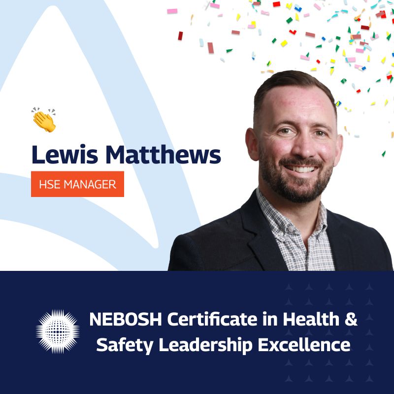 A professional celebratory graphic featuring Lewis Matthews, the HSE Manager at Amaro, recognized for achieving the NEBOSH Certificate in Health & Safety Leadership Excellence. Lewis is a smiling man with a beard, dressed in a suit jacket over a checkered shirt. The graphic includes a festive background with multicolored confetti and design elements, including a waving hand emoji. A special emblem for the NEBOSH certification is also displayed.