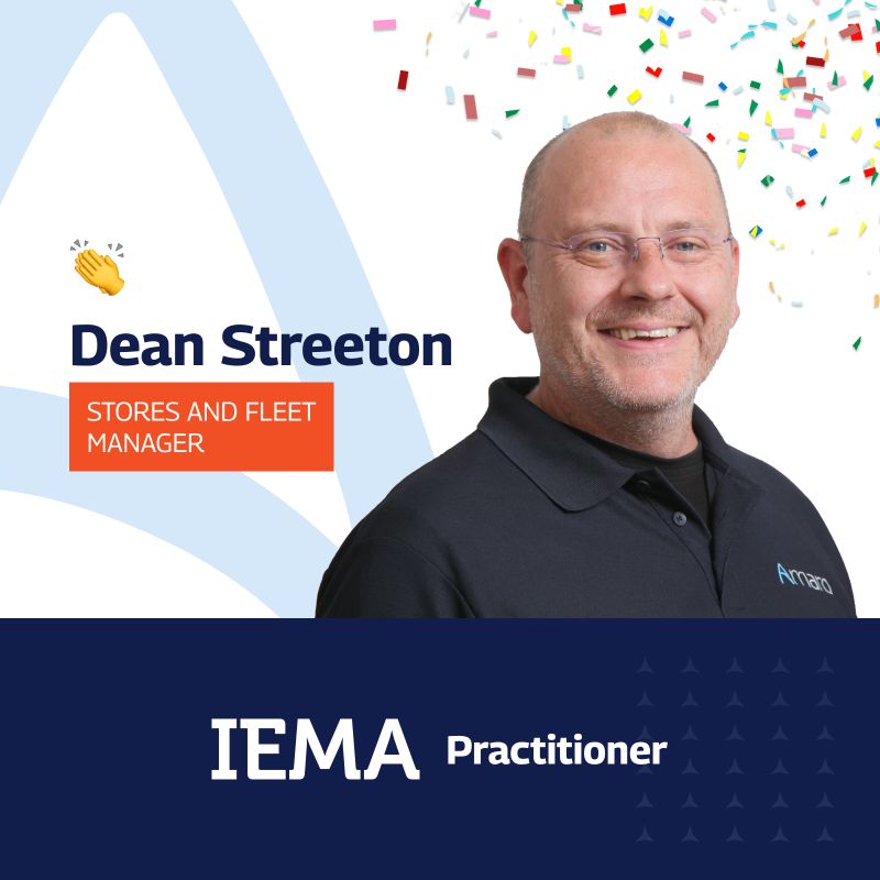 A celebratory professional profile image featuring Dean Streeton, who is smiling and dressed in a black polo shirt with the ‘Amaro’ logo. The graphic includes a festive background with colorful confetti. Text labels identify him as the ‘Stores and Fleet Manager’ and an ‘IEMA Practitioner,’ with a waving hand emoji and a triangular design element in the background.